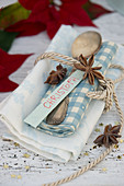 Napkins with silver spoons, star anise and name tags