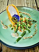 Roast chicken coated in cornflakes with green asparagus and flaxseed