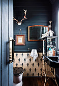 Glance into the bathroom with dark blue wooden paneling in the former church