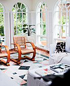 Designer chairs in the winter garden with arched windows