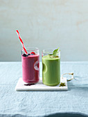 A berry smoothie made with acai powder and chia seeds and a green smoothie made with spinach, avocado and moringa