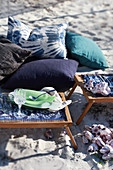 Cushions and folding trays on sandy beach