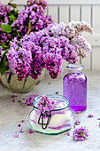 Sugar with lilac blossoms, lilac flower syrup and lilac blossoms