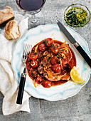 Pork chop with roasted cherry tomatoes and lemon