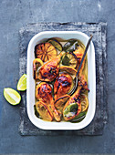 Chicken with lemon and lime in a sweet-and-sour garlic and curry marinade