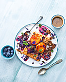 Waffles with roasted apricots and berry sauce