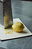 Lemon zest being grated with a vegetables grater