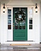 Front door decorated with Christmas wreath