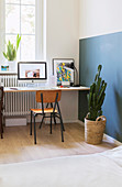 Simple desk and chair below window in bedroom