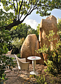 Seating area surrounded by granite boulders in garden