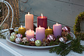 Bowl with candles and Christmas baubles as a Christmas decoration