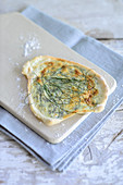 Unleavened chive bread on a chopping board