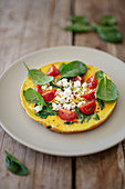 A frittata with spinach, tomatoes and feta