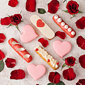 Eclairs with decorations and red roses