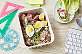 A quinoa bowl with roast beef, egg and cress for an office lunch