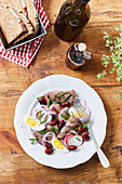 Beef salad with radishes, beans and egg