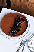 A chocolate tart with blackberries and blueberries
