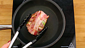 Bacon, avocado and egg being made