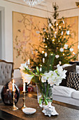 Festive bouquet of amaryllis and conifer branches