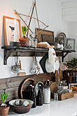 Ornaments in natural shades above grey desk in bedroom