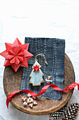 Paper star and Christmas tree on embroidered denim