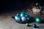 Easter background with painted Easter eggs in vintage style over dark background