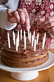A birthday cake being decorated with candles