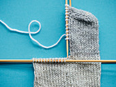 A sock being knitted: heel turn from the side