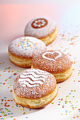 Doughnuts for carnival with various icing sugar patterns
