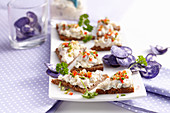 Wholemeal carnival snacks with soused herring cream and blue crisps
