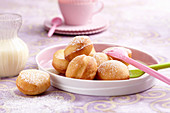 Deep-fried, sweet yeast dough balls with vanilla sauce and icing sugar