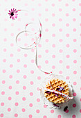 Waffle biscuits with a ribbon on a polka dot table cloth (seen from above)