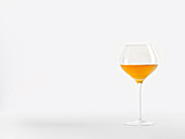 A glass of natural wine (orange wine)