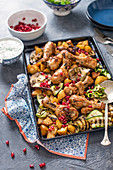 Chicken with cumin and smoked paprika, roasted vegetables, pomegranate and minted yoghurt sauce