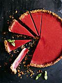Gluten, dairy free and refined sugar rhubarb and raspberry tart. With a hazelnut, toasted cocnut and gluten free flour base