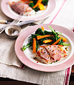 Fish fillets wrapped in ham with steamed vegetables