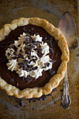 Chocolate pie with cream and chocolate shavings