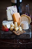 Cheese board still life with crackers and fruits