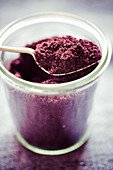 Acai powder in a glass with a spoon