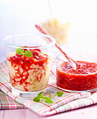 Vanilla rice pudding with strawberry sauce in small glasses