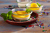 Lime cream with mango in a glass bowl