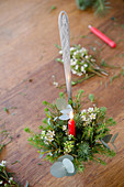 Festive flower arrangement with candle in ladle