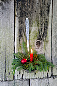 Festive arrangement with candle in ladle