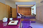 Modern studio apartment with purple accents