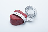 A raw fillet of beef with a tape measure