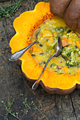 Pumpkin broccoli soup in a pumpkin bowl