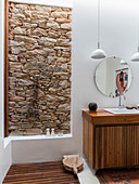 Open, floor-level shower with stone wall