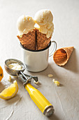 Lemon icecream in cones with an ice cream scoop