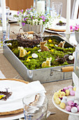 Set table with Easter arrangement in vintage baking tray