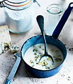 Blue cheese sauce with milk and flour in a saucepan